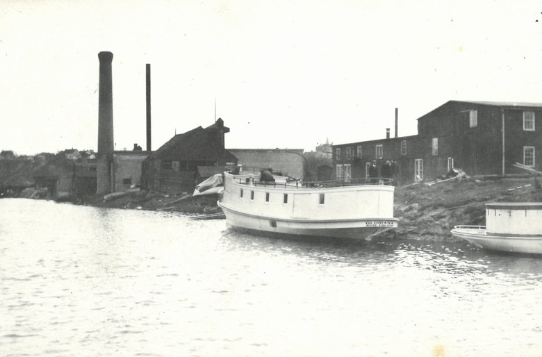 Image of GLORIANNA sitting in river outside Burger Boat Company