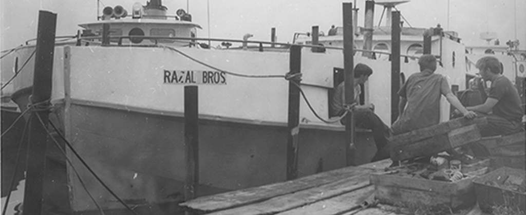 Image of RAZAL BROS. sitting in river