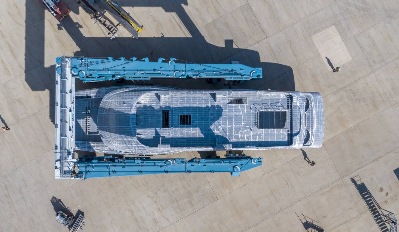 Aerial view of house module being moved by travelift