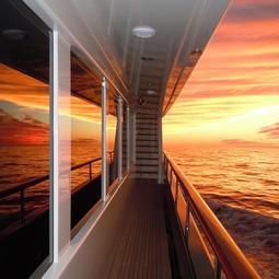 Vivid sunset reflected off windows of yacht